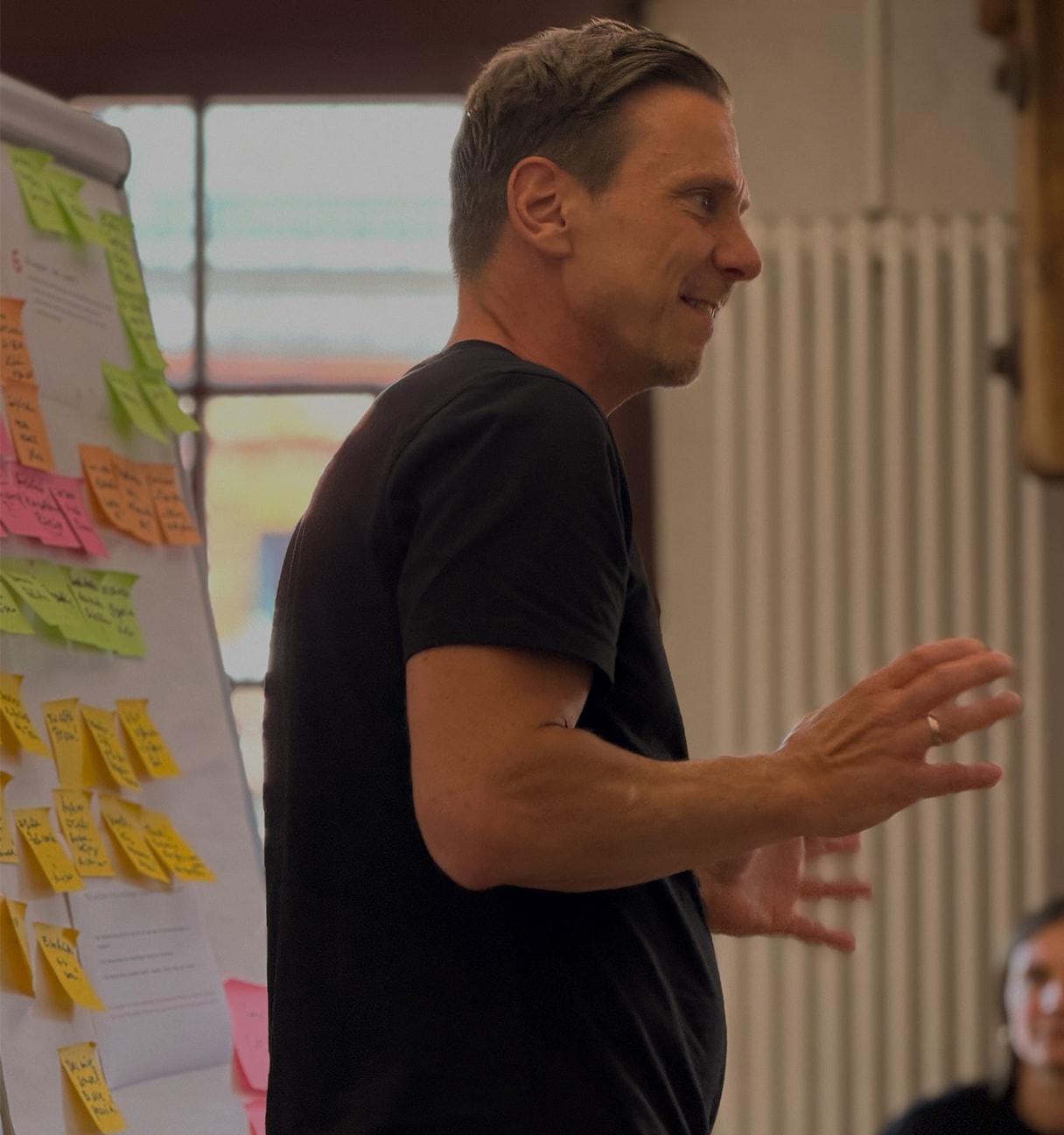 man before flipchart with postits
