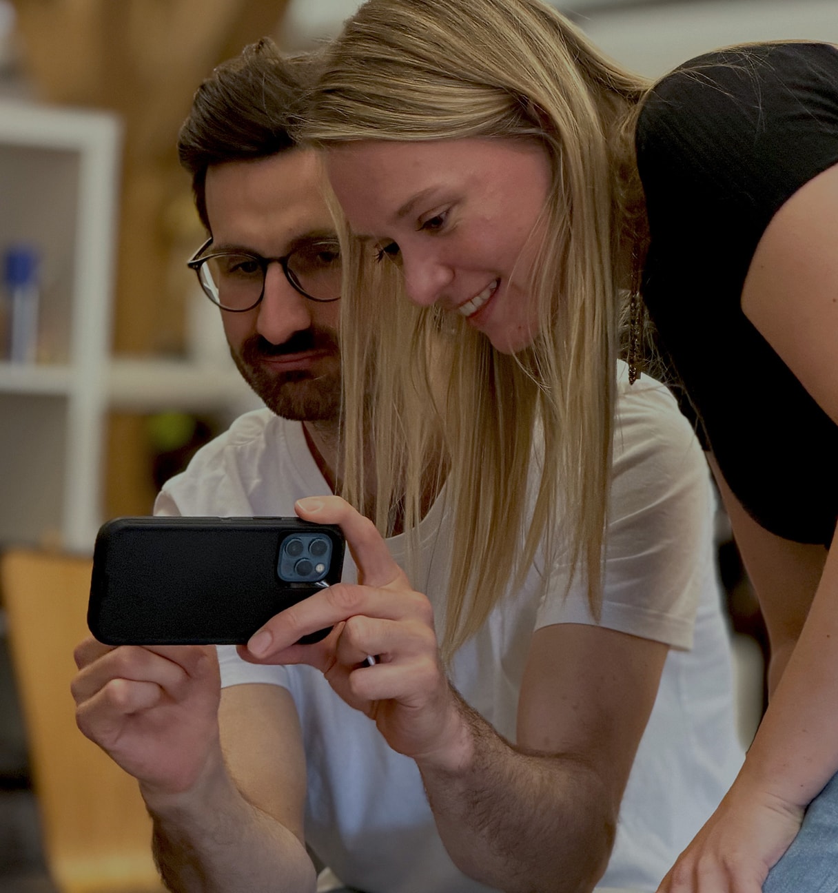 woman and man looking at mobile phone